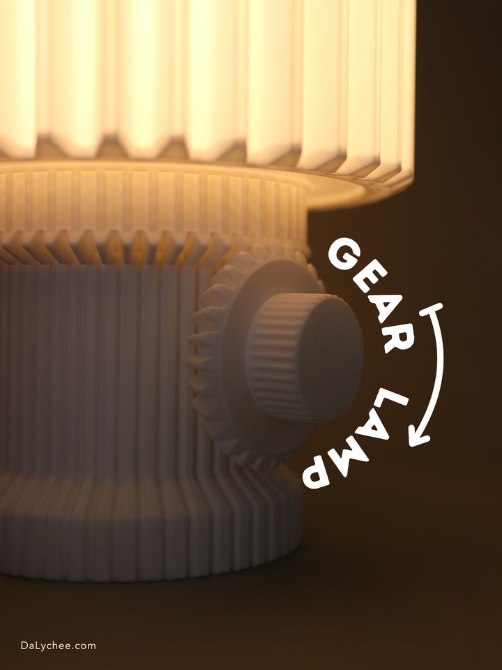 Close view of the glowing Gear Lamp and its gear-shaped control beside a rotation graphic