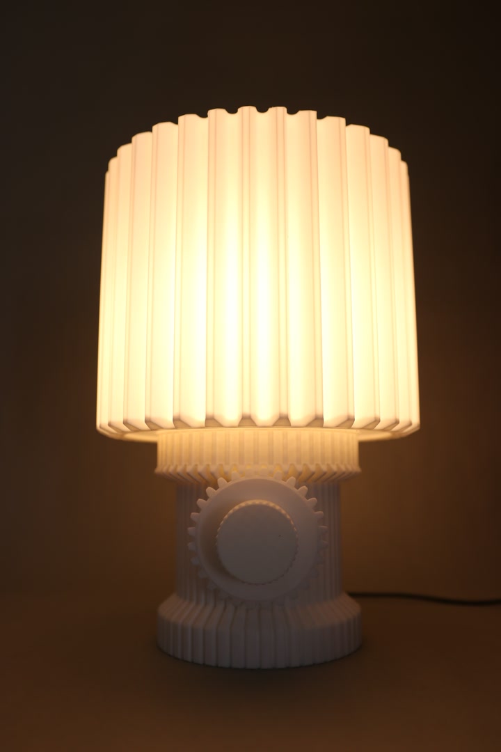 Complete Gear Lamp glowing in a dark studio