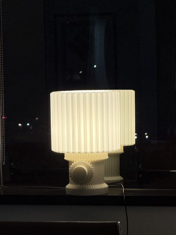 Gear Lamp glowing beside a dark nighttime window