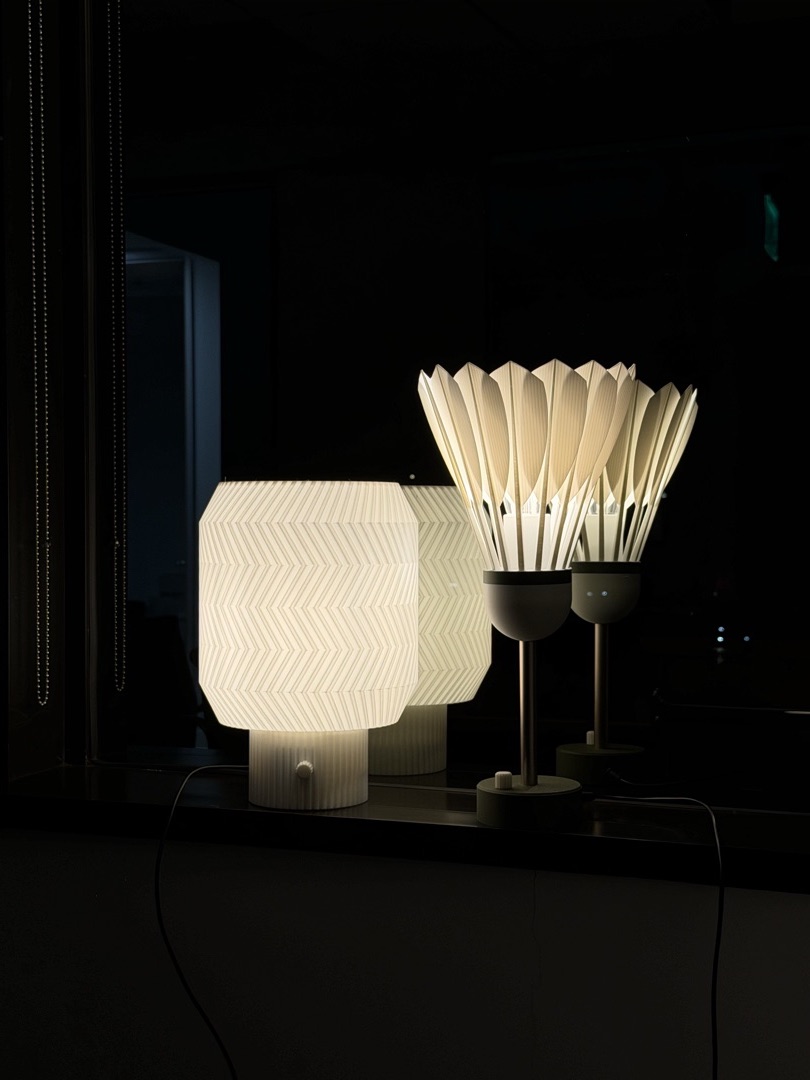 Shuttlecock Lamp and Origami Lamp standing upright in the Dalychee studio