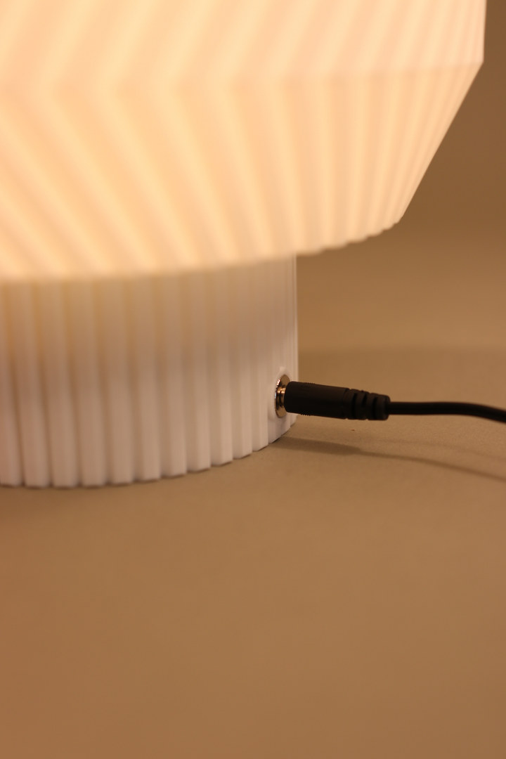 Close view of the Origami Lamp power connection at the ribbed base