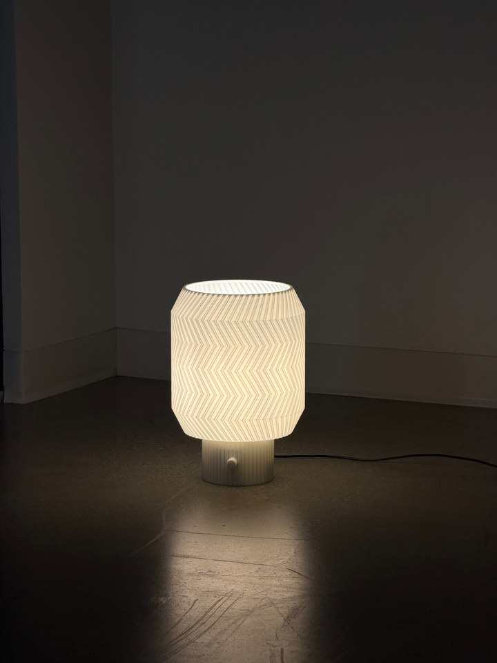 Origami Lamp casting a pool of light across a dark floor