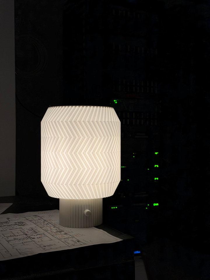Origami Lamp glowing beside studio equipment and sheet music