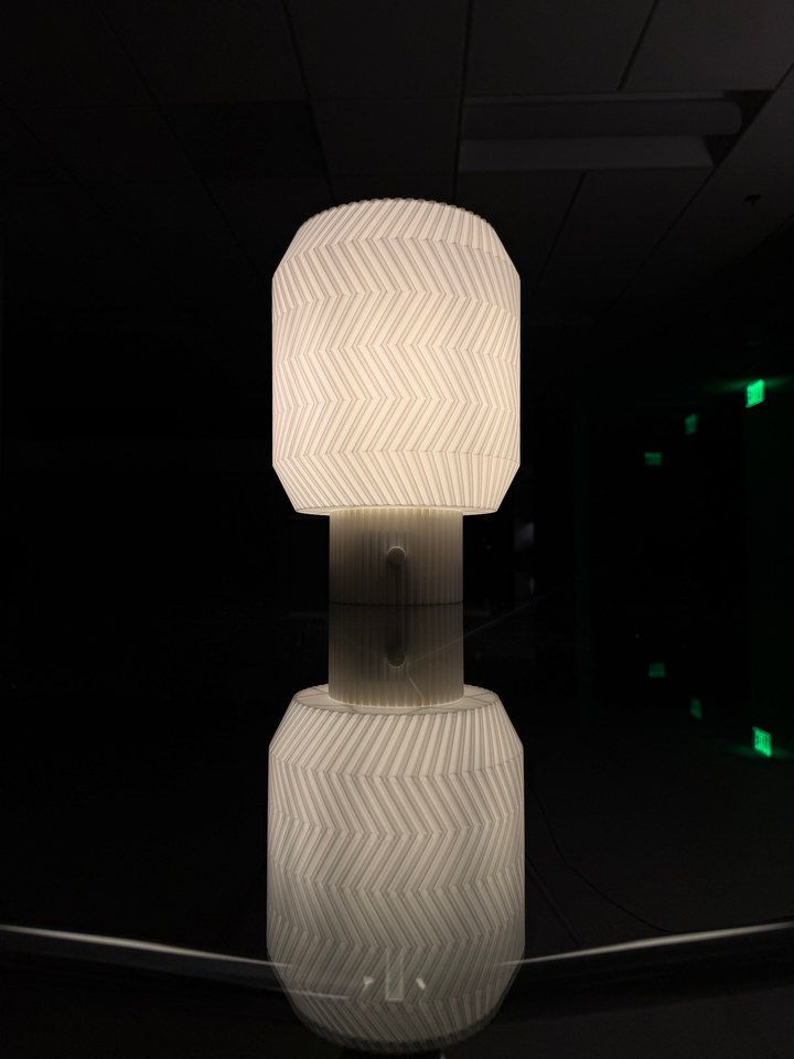 Origami Lamp and its full reflection in a dark room