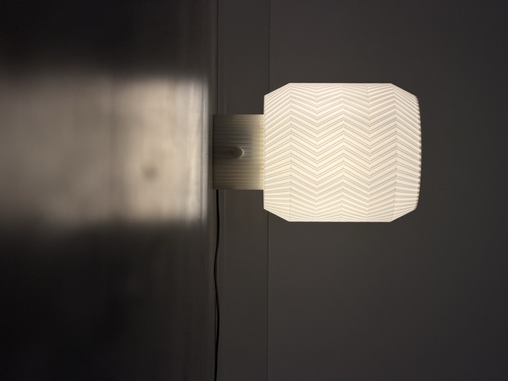 Origami Lamp reflected on a dark tabletop