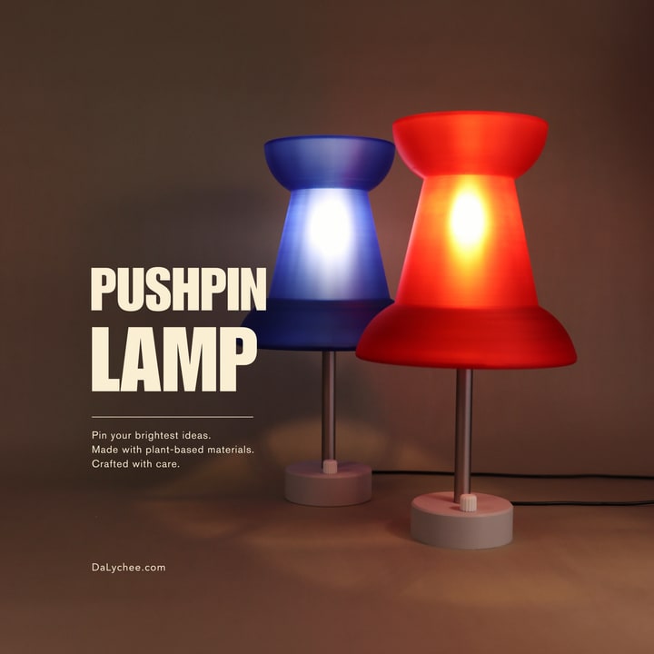 Pushpin Lamp red and blue colorways on a warm studio cover