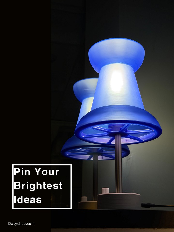 Low-angle view of a glowing blue Pushpin Lamp and its reflection