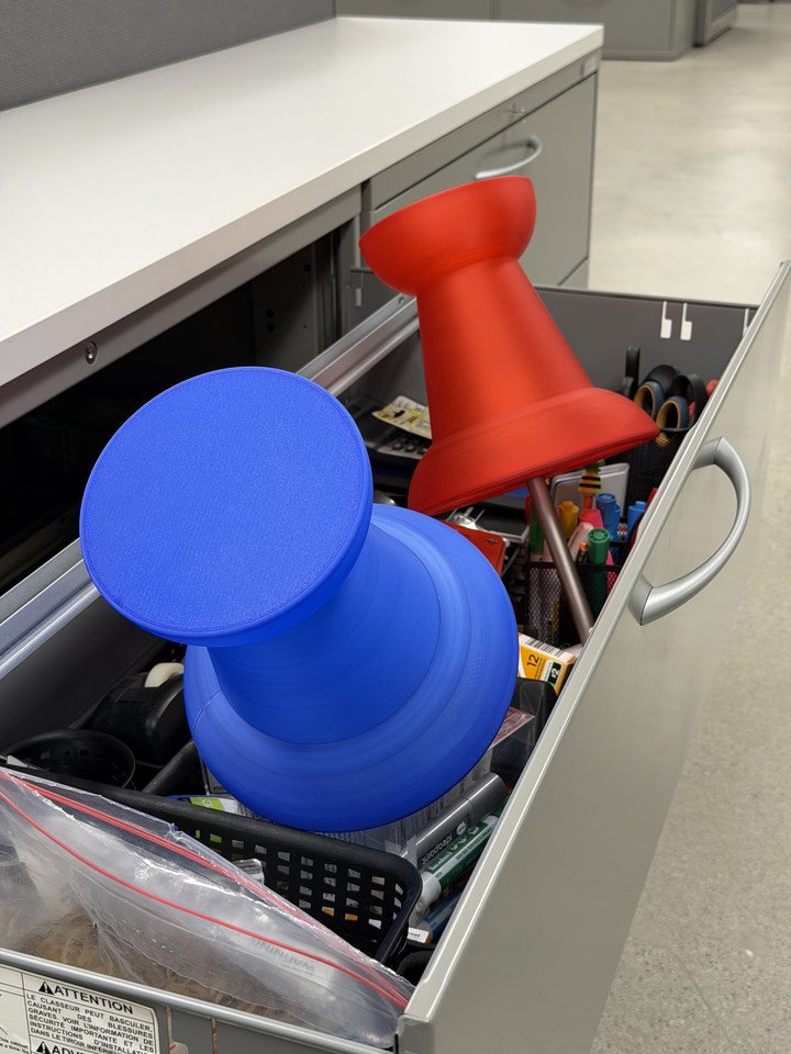Red and blue Pushpin Lamp shades resting in an open dishwasher rack