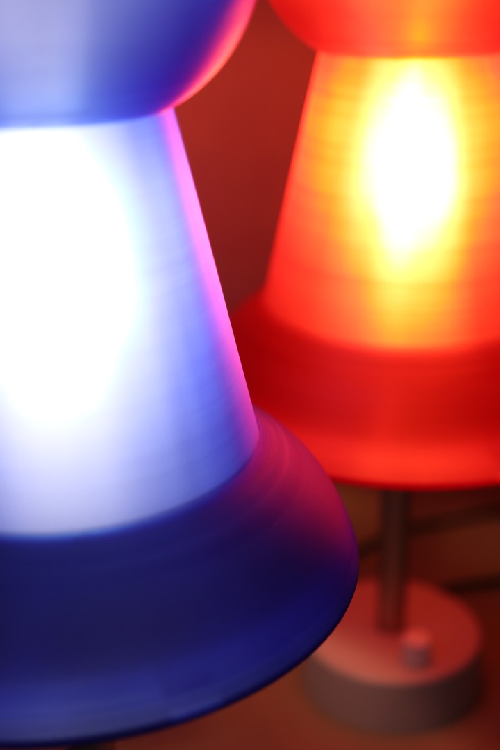 Close view of blue and red Pushpin Lamp shades glowing together