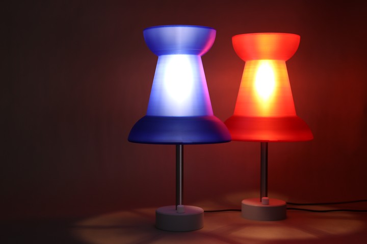 Red and blue Pushpin Lamps glowing together in a dark studio