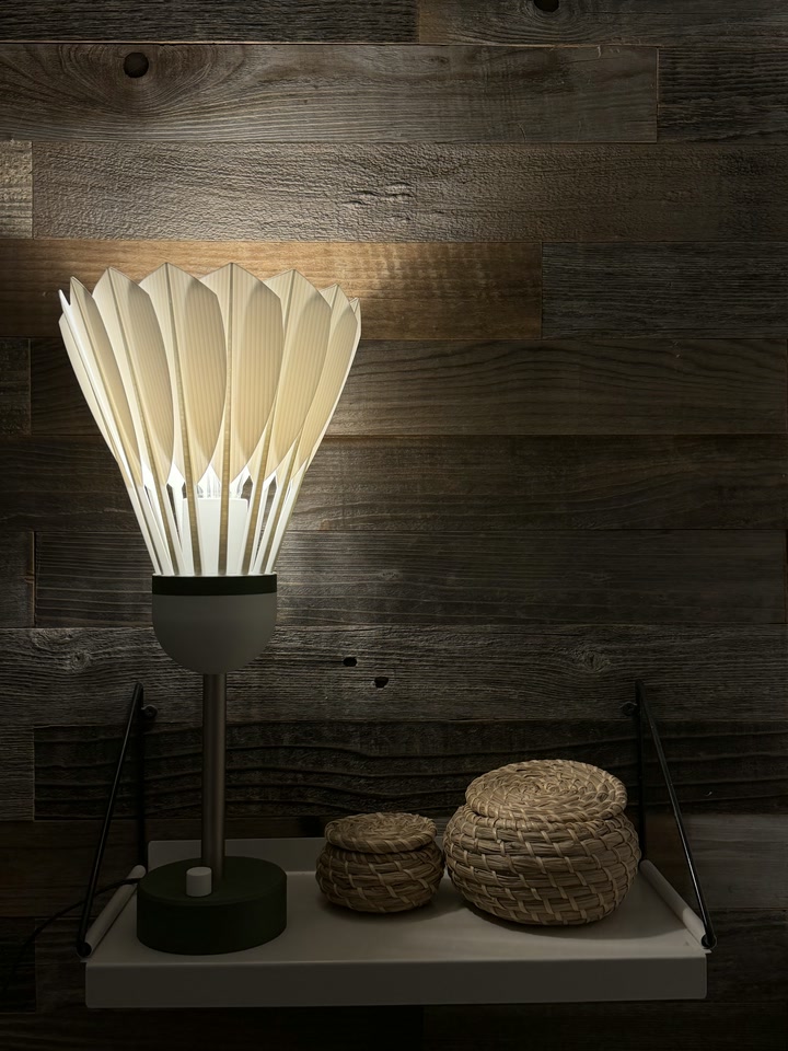 Shuttlecock Lamp displayed on a wall shelf with woven baskets