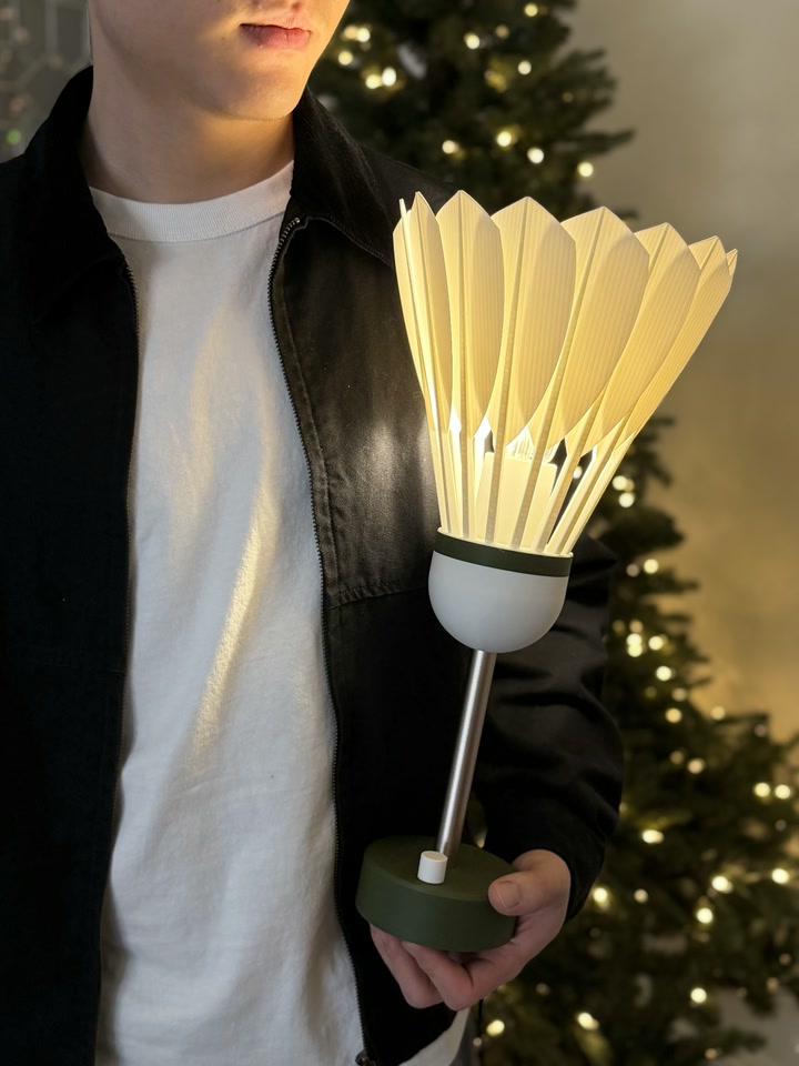 Person holding the glowing Shuttlecock Lamp