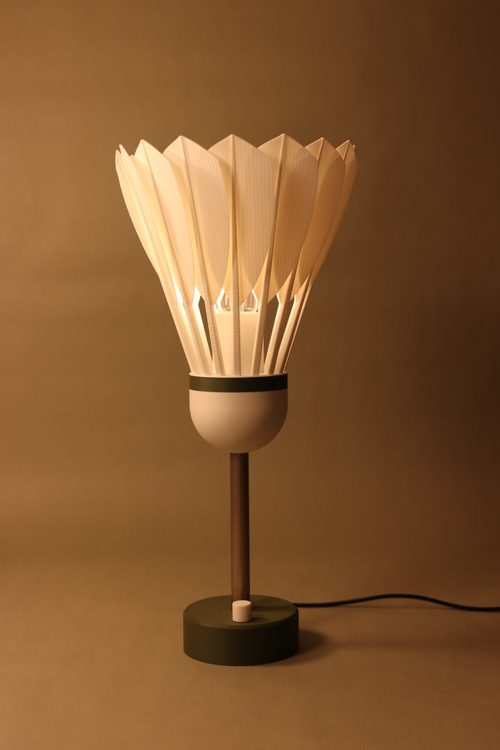 Shuttlecock Lamp glowing in warm studio light
