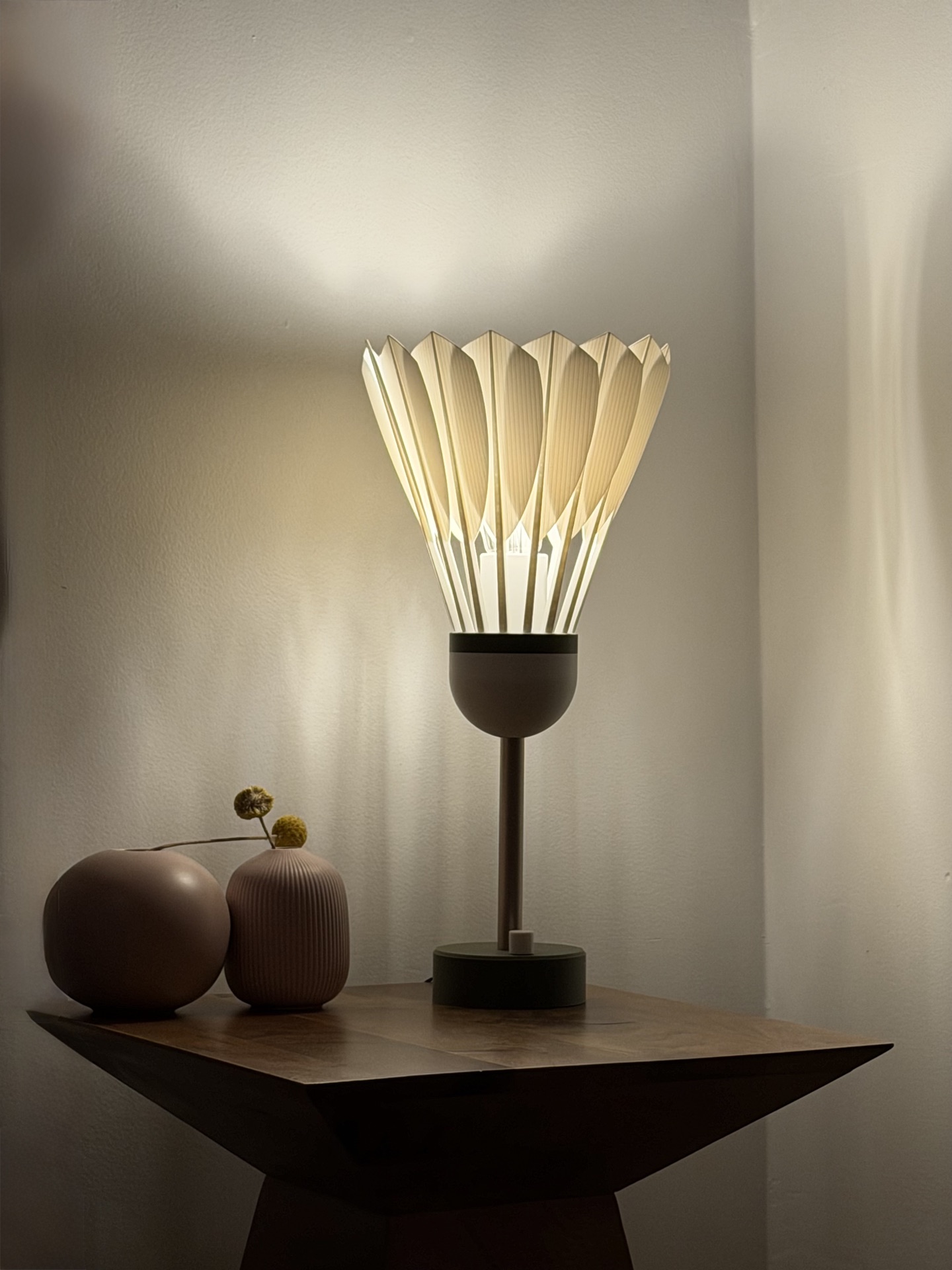 Shuttlecock Lamp illuminated on a side table
