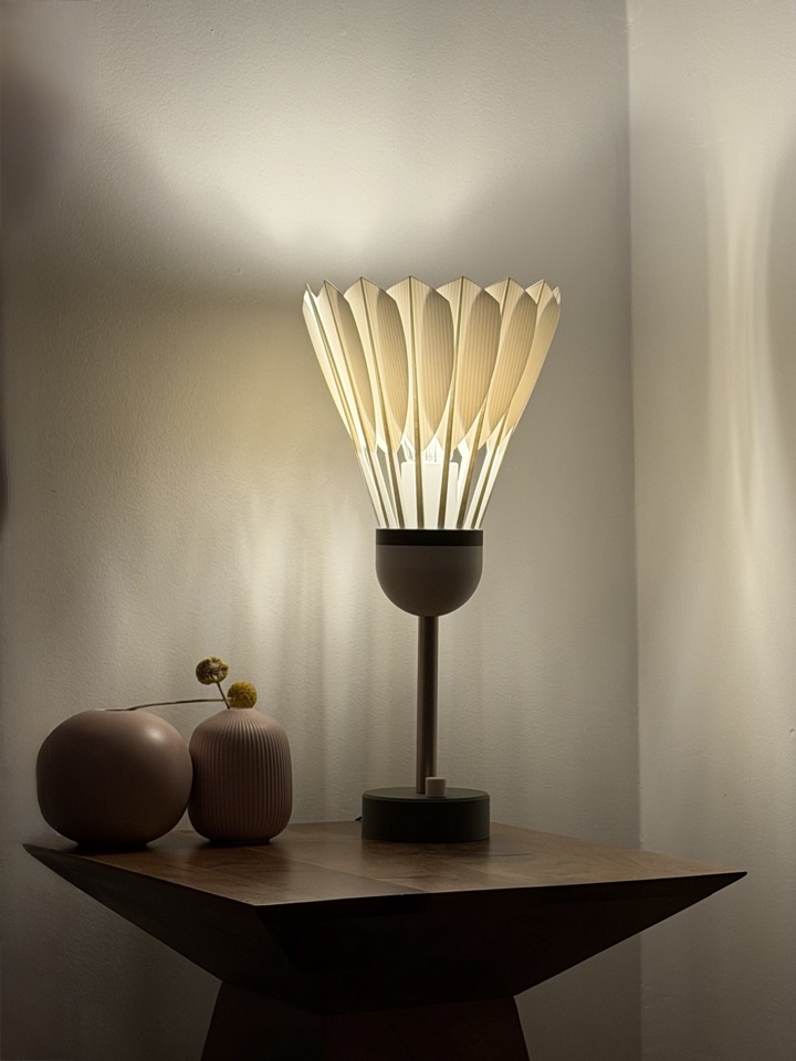 Shuttlecock Lamp illuminated on a side table